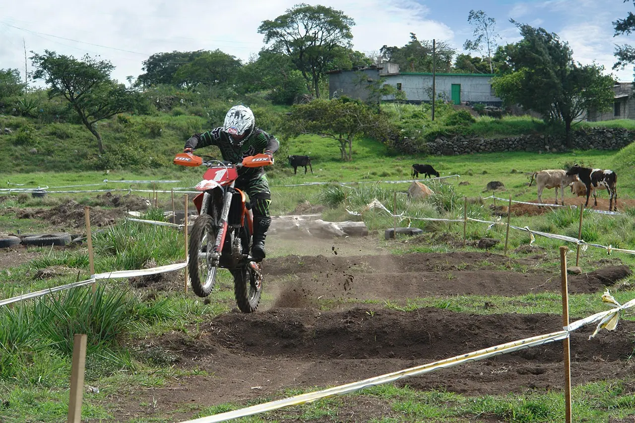 Dirt bike rider moving through a taped motocross course